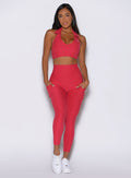 front view of a model wearing the Toned 7/8 Leggings in Victory Ruby color