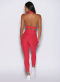 back side view of a model wearing the Toned 7/8 Leggings in Victory Ruby color