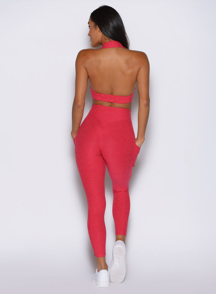 back side view of a model wearing the Toned 7/8 Leggings in Victory Ruby color