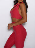 close up left side view of a model wearing the Toned 7/8 Leggings in Victory Ruby color