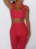 close up front view of a model wearing the Toned 7/8 Leggings in Victory Ruby color