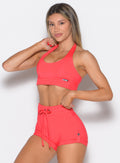 Raspberry Blush Trailblaze Sports Bra with a halter neck and cinched band for high-impact yoga.