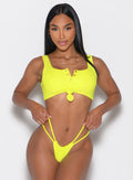 Model facing forward wearing our Tropical Tease Bikini Top in Neon Yellow color and the matching Tropical Tease Bikini Bottoms
