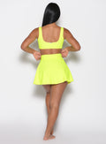 back profile view of a model in our Tropical Tease Skirt in Neon Yellow color and the matching Tropical Tease Bikini Top