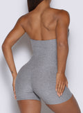 close up back profile view of a model wearing the True form Bodysuit shorts in dark and stormy color