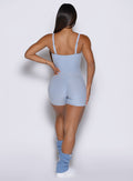 model captured from the back side wearing the True form Bodysuit shorts in Niagara mist color