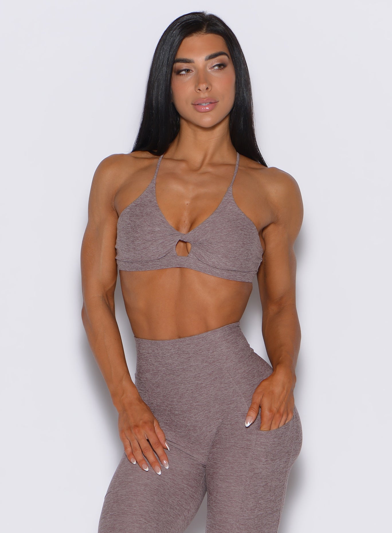front profile vew of a model wearing our tiny twist bra in london fog color along with the matching leggings 