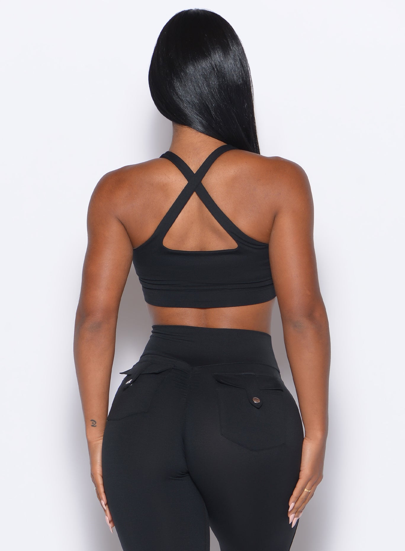 Black Two Way Bra featuring a strappy open back and sculpting support for intense gym sessions.