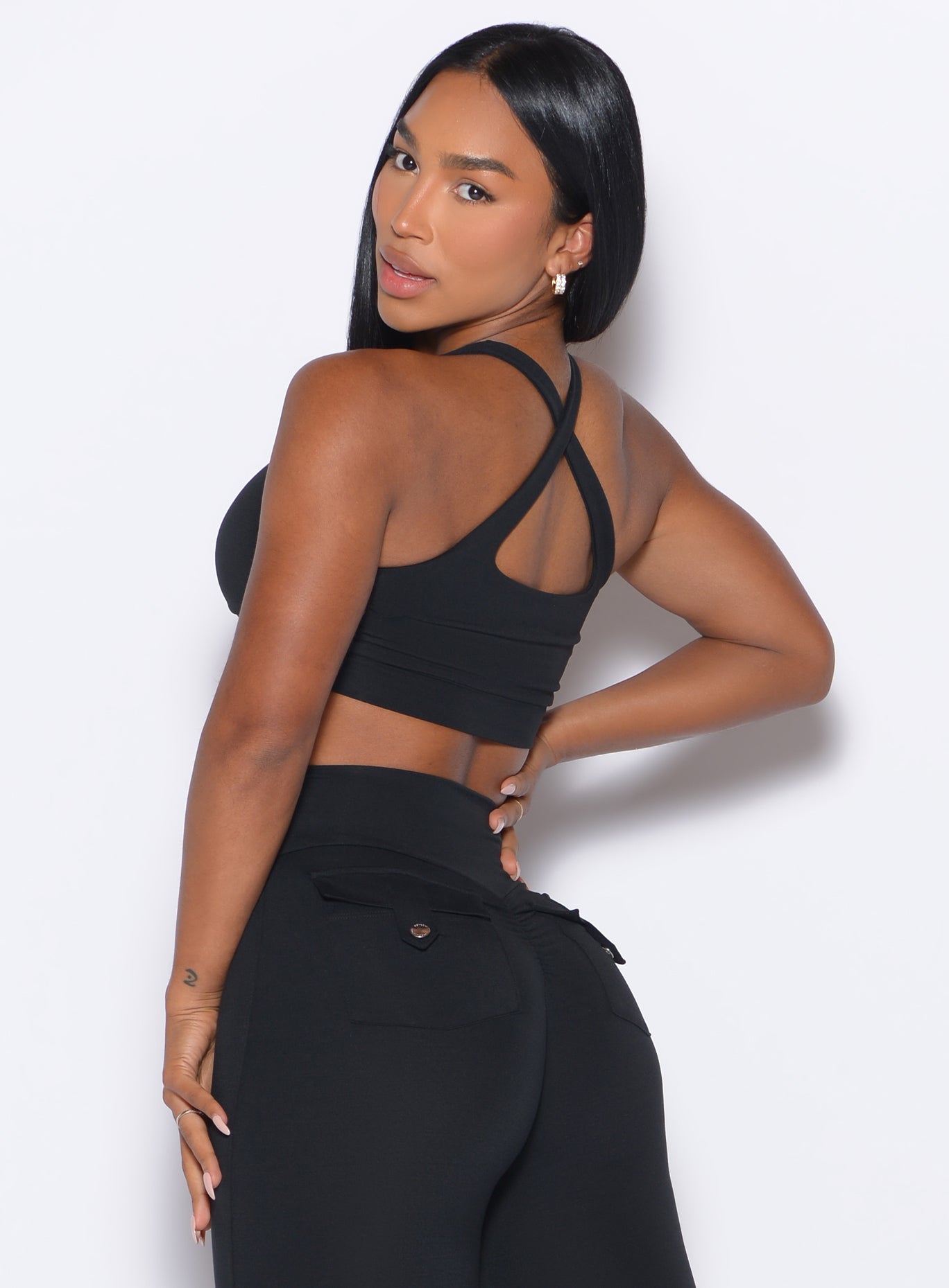 Black Two Way Bra styled with a sleek open back and push-up fit for high-performance training.