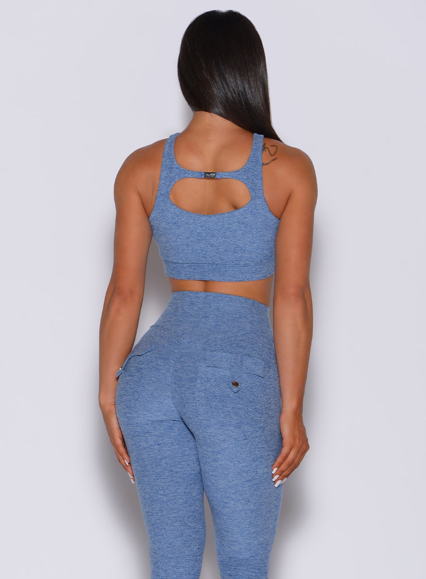 back profile picture of a model wearing our two way bra in sky blue and a matching leggings 