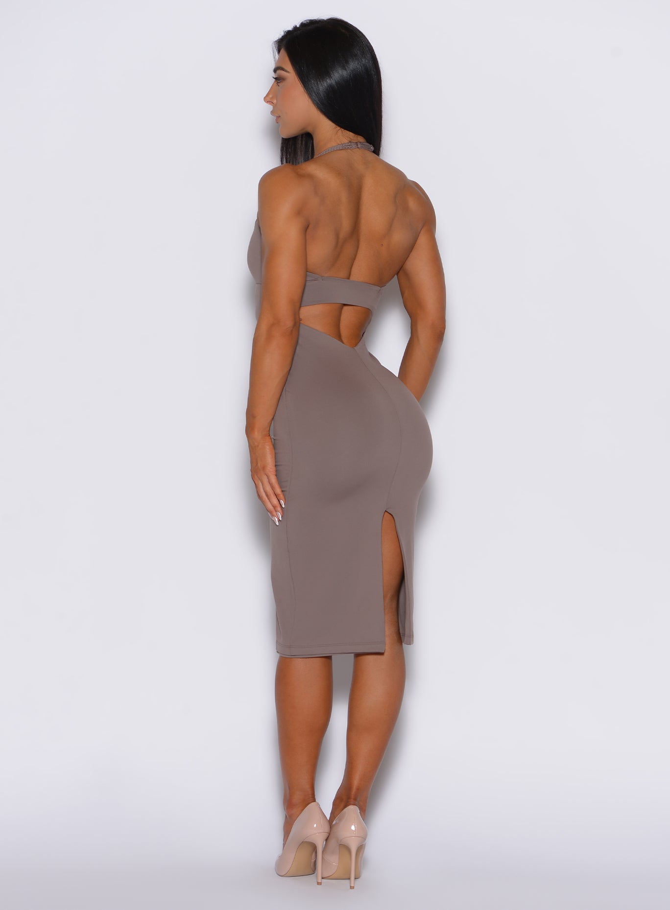back profile view of a model wearing our unforgettable dress in espresso color