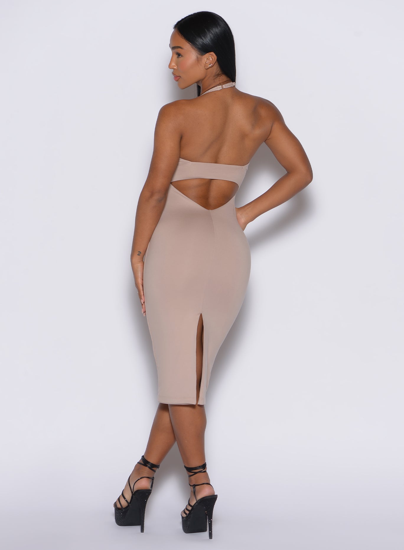 back profile view of a model in our unforgettable dress in camel color