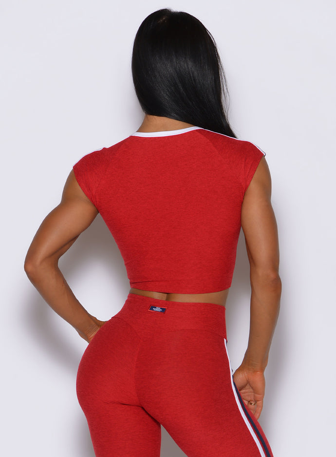 Sculpting United Tee Sunset Red top viewed from behind, showcasing a clean cut and sporty seams.