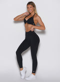 front left side profile view of a model wearing our Uplift Peach Leggings in black color