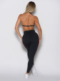 back profile view of a model wearing our Uplift Peach Leggings in black color