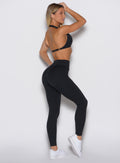 right side profile view of a model wearing our Uplift Peach Leggings in black color