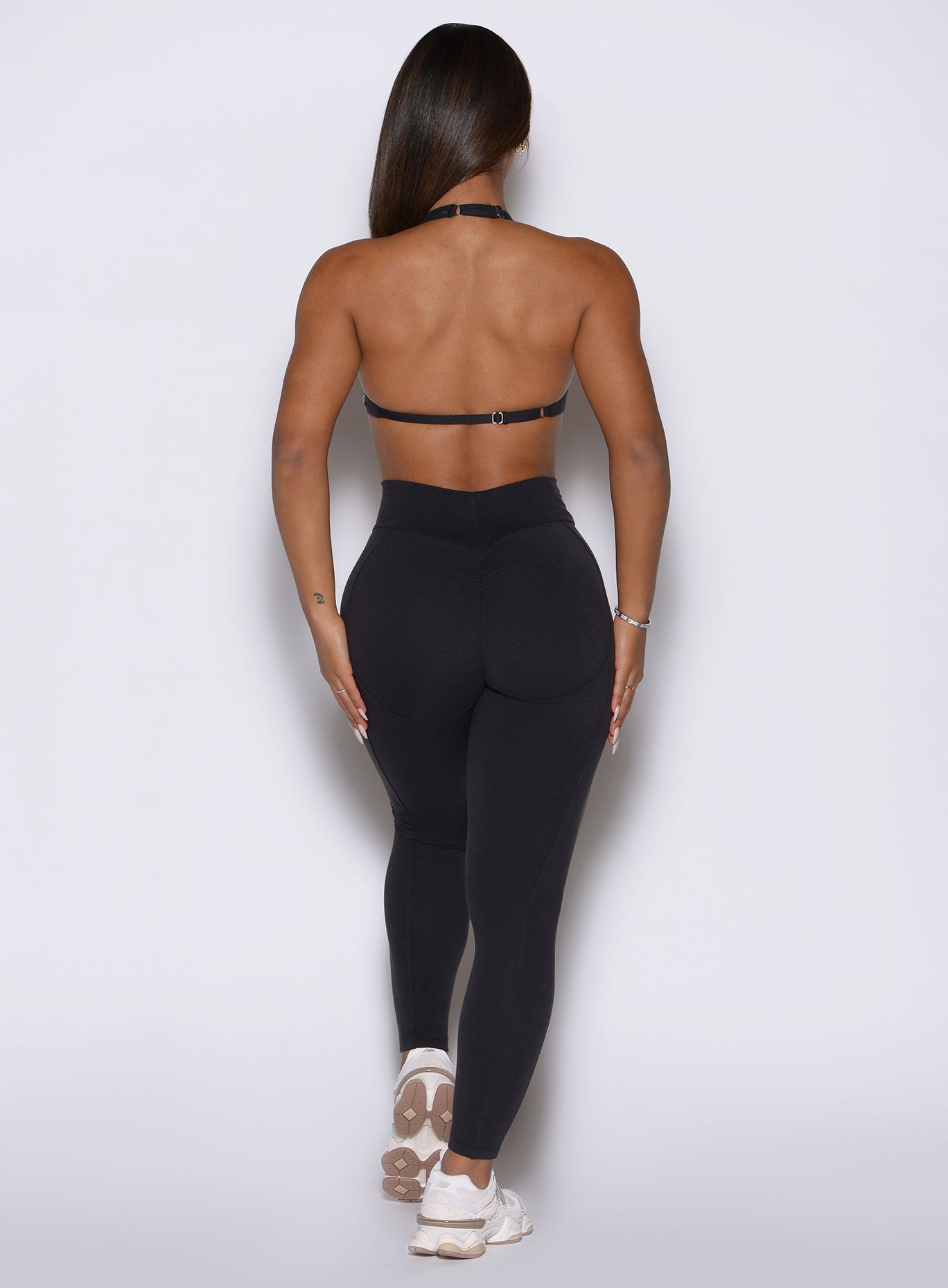 Glute-enhancing scrunch butt seam on Obsidian Black Bombshell Sportswear Uplift Peach Leggings