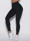 Close up front view of a model wearing our Uplift Peach Leggings in black color