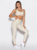 front profile view of a model wearing the Uplift peach leggings in pearl white color