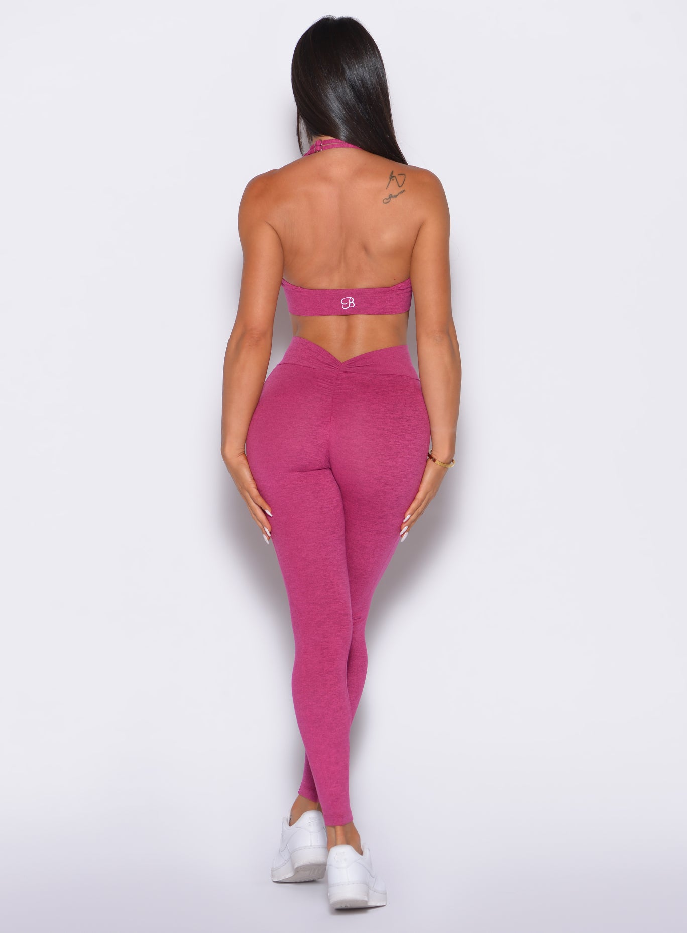 Sculpting Fuchsia V Back Leggings featuring a figure-flattering V-scrunch and convenient pockets.