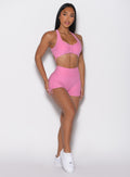 front right side profile view of a model wearing the V back toggle shorts in Bubblegum color