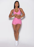 front profile view of a model looking to the left wearing the V back toggle shorts in Bubblegum color