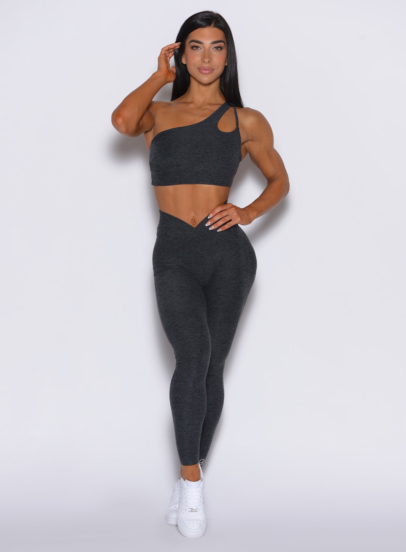 front profile view of a model wearing our V Active Leggings in charcoal color along with the matching top 