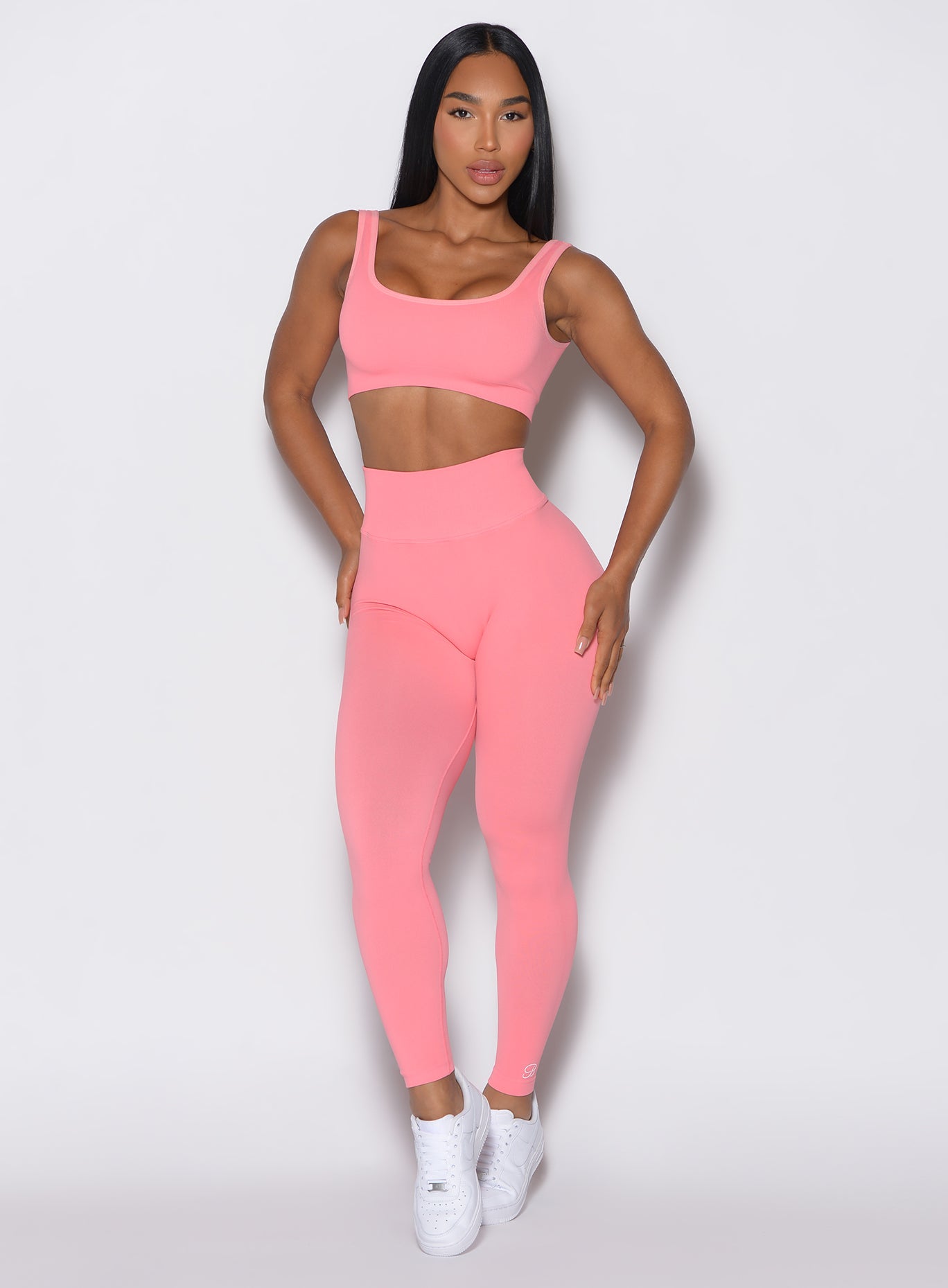 front profile of model wearing the v back seamless leggings set in flamingo