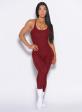 front profile view of our model with one hand on her waist wearing the Athletic Bodysuit in Black Cherry color