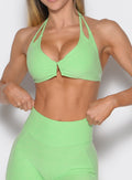 close up front profile view of a model wearing the Voltage sports bra in Electric green color