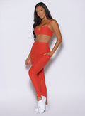 front left side profile view of a model wearing the Wave Wire Leggings in firestorm color
