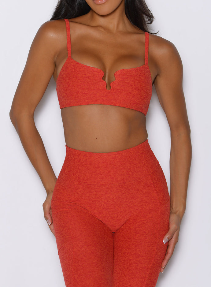 close up front view of a model wearing the Wave wire bra in firestorm color