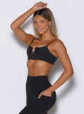 front left side view of a model with one hand resting on top of her head wearing the Wave wire bra in heathered black color