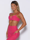 front left side profile view of a model wearing the Wave wire bra in pink paradise color