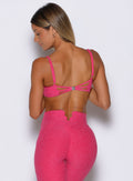 back profile view of a model wearing the Wave wire bra in pink paradise color