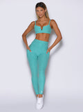 front profile view of a model with both hands inside the side pockets wearing the Wave Wire Leggings in Crystal current color