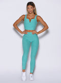 front view of a model with both hands on her waist wearing the Wave Wire Leggings in Crystal current color