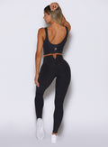 back profile view of a model facing to the left side wearing the Wave Wire Leggings in Heathered Black color