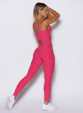 right side profile view of a model wearing the Wave Wire Leggings in pink paradise color