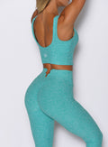back right side profile view of a model wearing the Wave wire tank in Crystal Current color