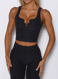 close up front view of a model wearing the Wave wire tank in heathered black color