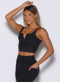 front left side profile view of a model wearing the Wave wire tank in heathered black color