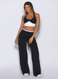Front view of model wearing Bombshell Sportswear wide leg joggers in Black color, featuring relaxed flowy fit
