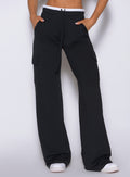 Bombshell Sportswear black wide-leg cargo lounge pants side detail featuring high-waist fit, soft drape fabric, side cargo pockets, relaxed silhouette, and elevated women’s athleisure styling