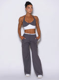 front profile view of a model wearing Bombshell Sportswear wide-leg cargo lounge pants designed for everyday wear, featuring a soft ‘butter-like’ fabric, adjustable drawcord waistband, flowy flattering fit, and functional side pockets with cargo detailing.