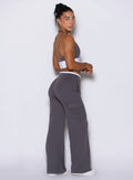 Right side profile view of a model wearing Bombshell Sportswear wide-leg cargo lounge pants, with side pockets and adjustable drawcord, designed for everyday wear