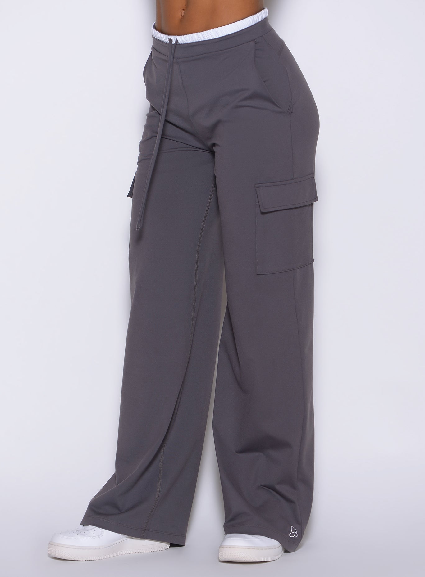 left side view of the Bombshell Sportswear wide-leg cargo lounge pants in champion gray color, with side pockets and adjustable drawcord, designed for everyday wear