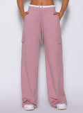 Close-up view of model wearing Bombshell Sportswear wide leg joggers in Cosmetic Pink color, highlighting relaxed fit and smooth lightweight fabric