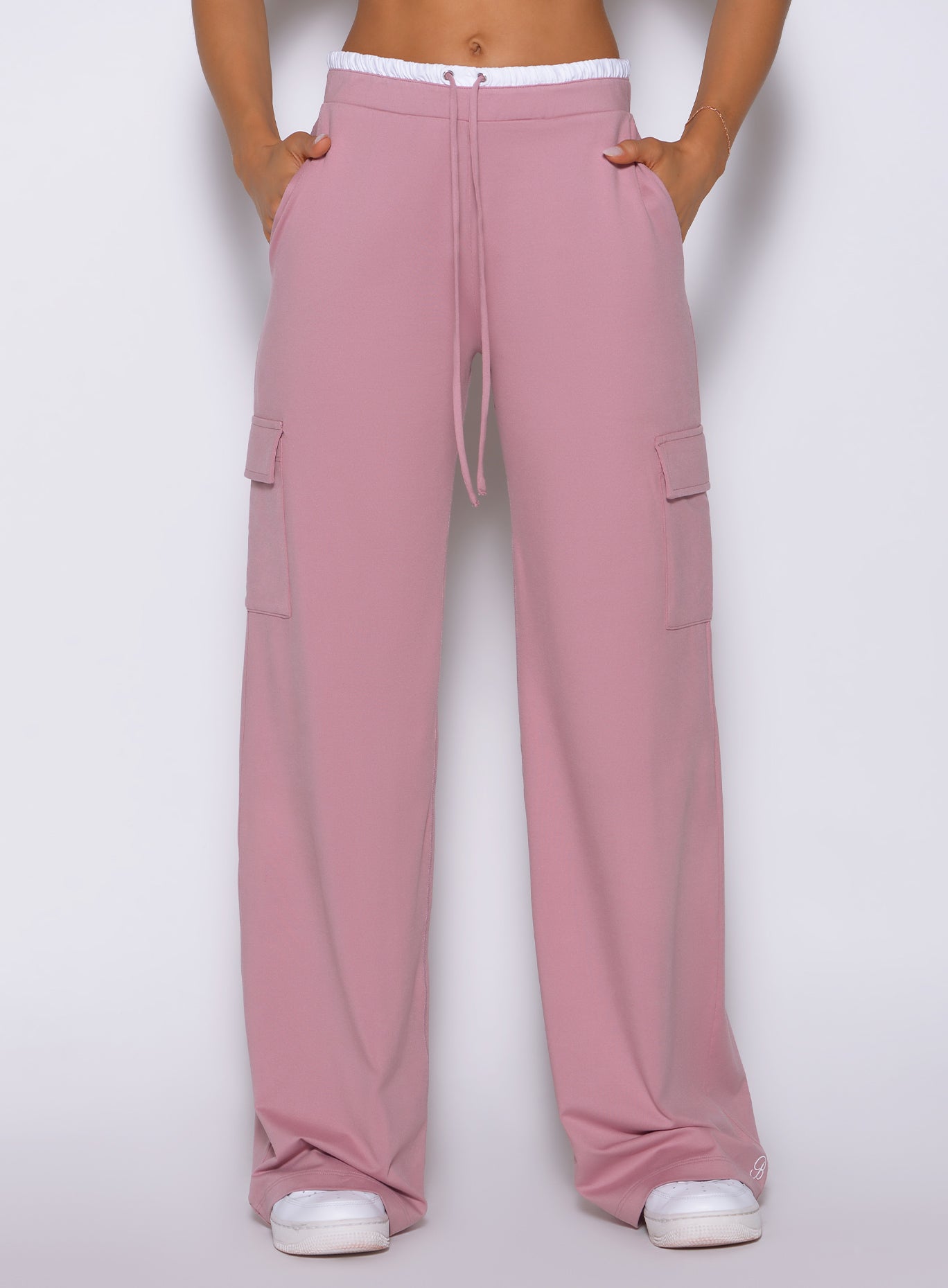 Close-up view of model wearing Bombshell Sportswear wide leg joggers in Cosmetic Pink color, highlighting relaxed fit and smooth lightweight fabric