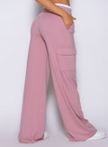 Rear close-up view of model wearing Bombshell Sportswear wide leg joggers in Cosmetic Pink color, highlighting relaxed fit and smooth lightweight fabric